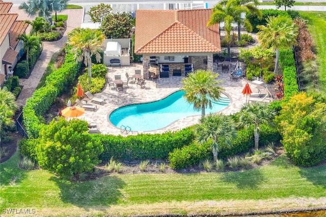 community pool with a patio area and a lawn