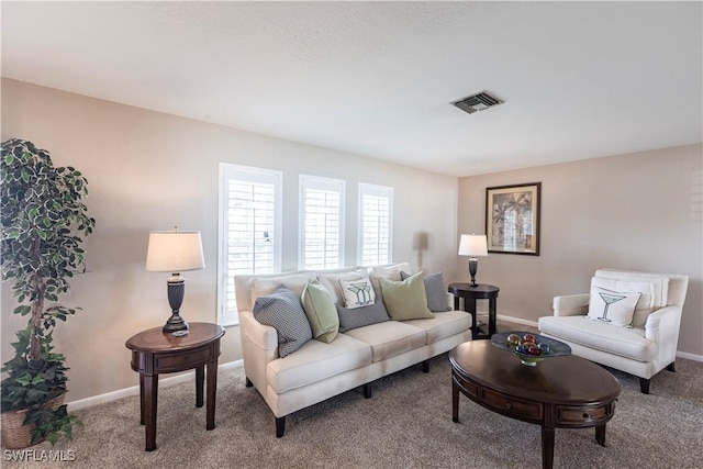 carpeted living room featuring visible vents and baseboards