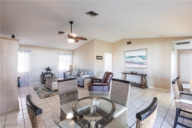 living room with lofted ceiling, light tile patterned flooring, and visible vents