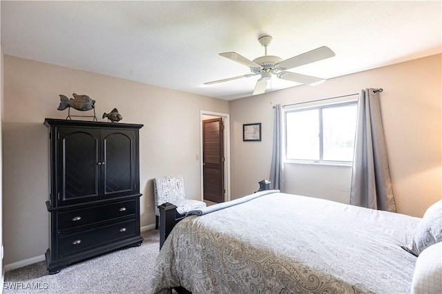 bedroom with light carpet, ceiling fan, and baseboards