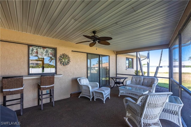 sunroom with a ceiling fan