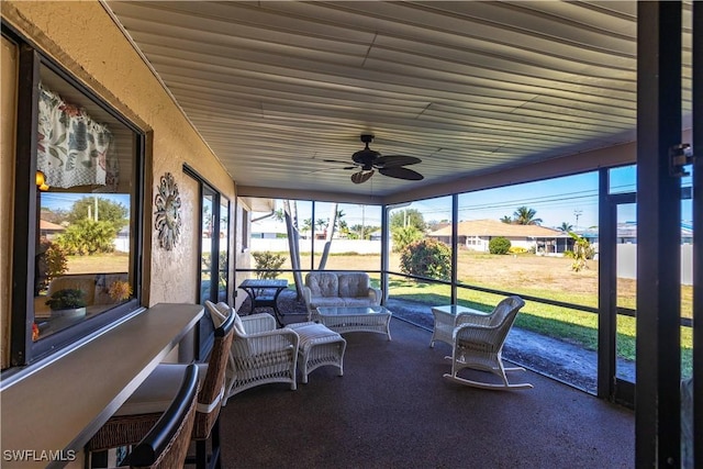 sunroom featuring a ceiling fan