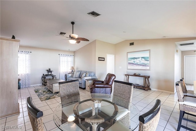 dining area featuring visible vents, vaulted ceiling, and light tile patterned floors