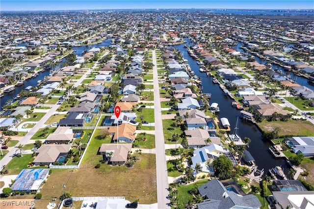 drone / aerial view featuring a residential view and a water view