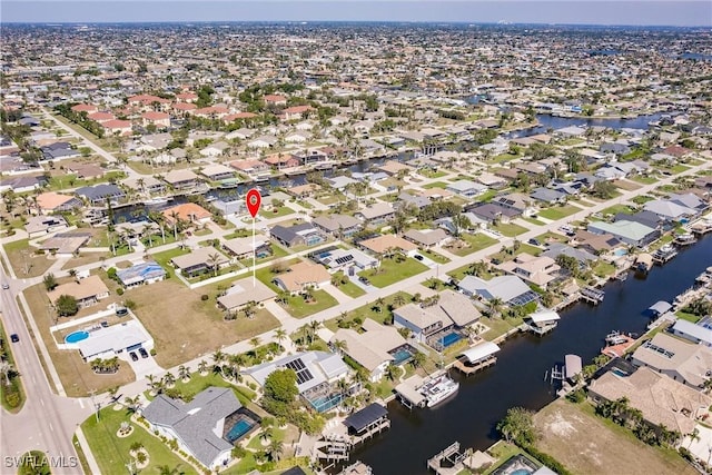 birds eye view of property featuring a water view and a residential view