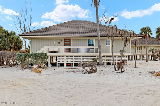 rear view of property featuring a deck