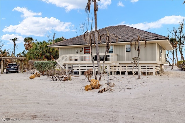 back of property with a carport