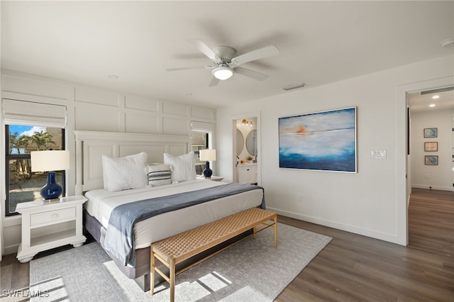 bedroom featuring a ceiling fan, dark wood finished floors, visible vents, and baseboards