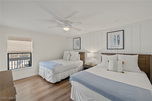 bedroom featuring baseboards, light wood-style flooring, and a ceiling fan