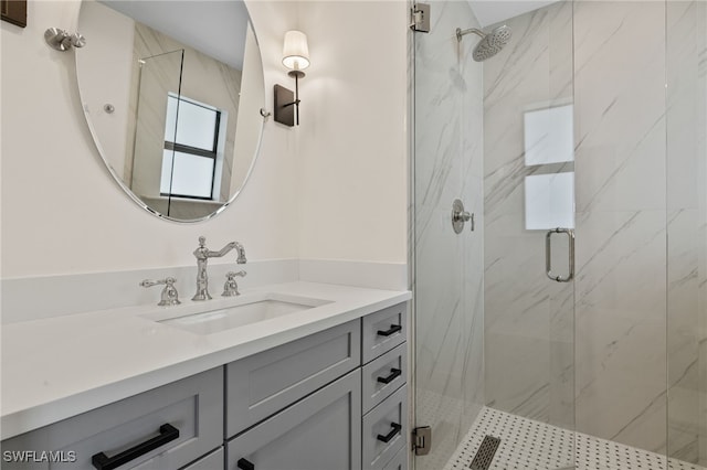 full bathroom featuring vanity and a marble finish shower