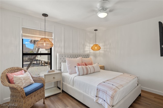 bedroom featuring baseboards and wood finished floors