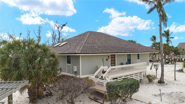 rear view of house featuring a deck