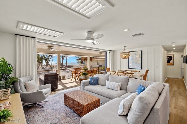 living area with a ceiling fan, light wood-type flooring, visible vents, and recessed lighting