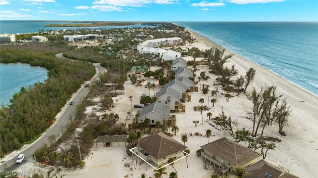 aerial view with a water view and a beach view