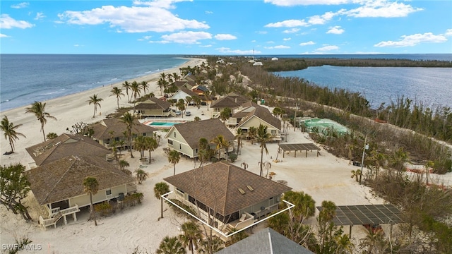 birds eye view of property with a water view and a view of the beach