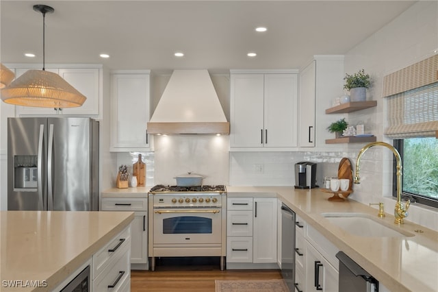 kitchen featuring open shelves, stainless steel appliances, light countertops, custom range hood, and white cabinetry