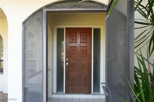 view of exterior entry with stucco siding