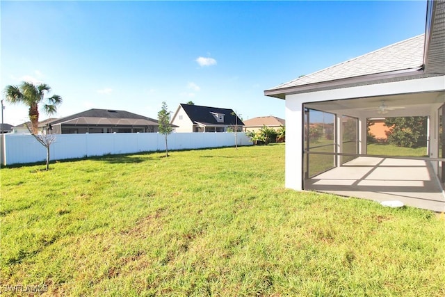 view of yard featuring a fenced backyard, ceiling fan, and a patio