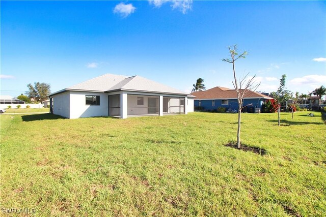 2314 SW 18th St, Cape Coral, FL 33991 - back of property featuring a sunroom and a yard