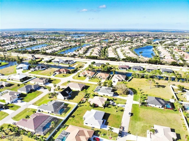 birds eye view of property with a water view and a residential view