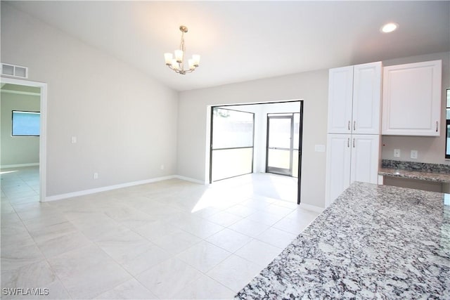 unfurnished dining area featuring recessed lighting, visible vents, baseboards, vaulted ceiling, and an inviting chandelier