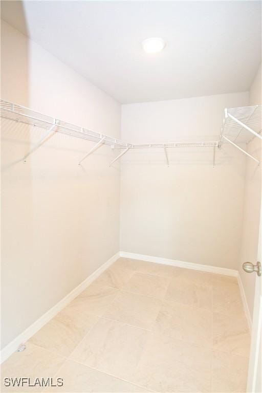 spacious closet featuring tile patterned flooring