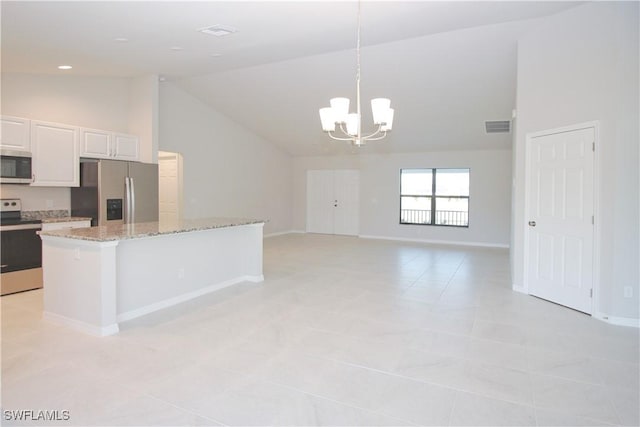 kitchen featuring visible vents, a kitchen island, appliances with stainless steel finishes, decorative light fixtures, and white cabinetry