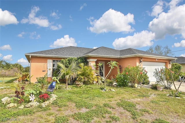 view of front of property featuring an attached garage, a front lawn, concrete driveway, and stucco siding