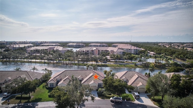 drone / aerial view featuring a water view and a residential view