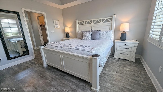 bedroom with dark wood-style floors and baseboards