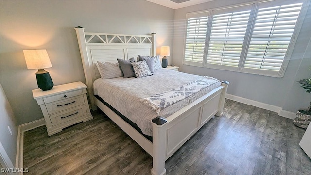 bedroom featuring baseboards and dark wood-style flooring