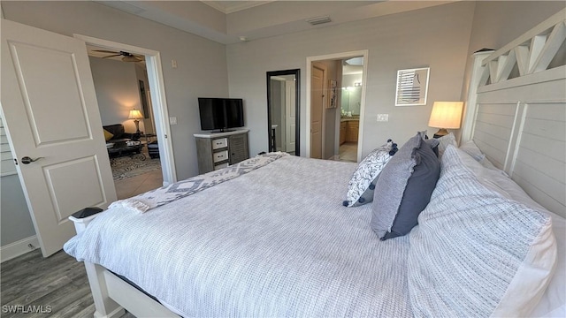 bedroom with visible vents and wood finished floors