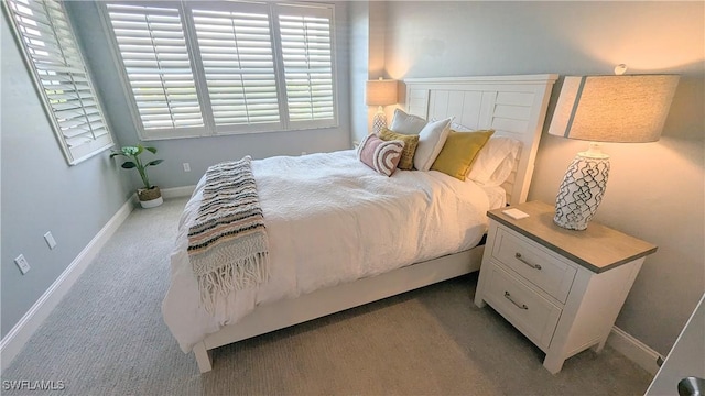 bedroom featuring carpet flooring and baseboards