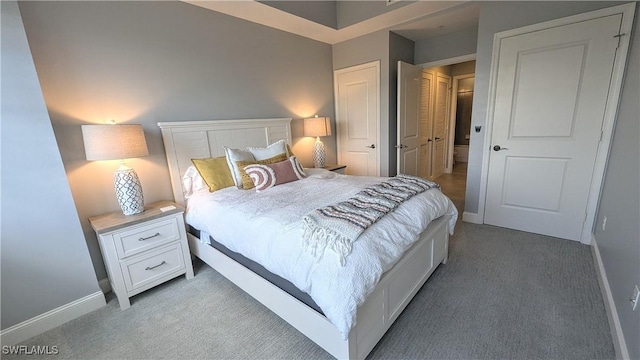 bedroom with carpet flooring and baseboards