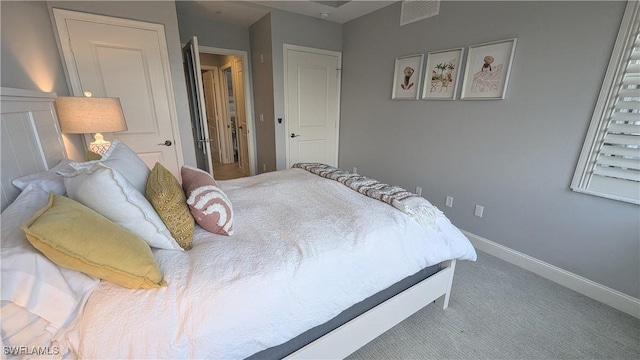 bedroom with carpet floors, baseboards, and visible vents