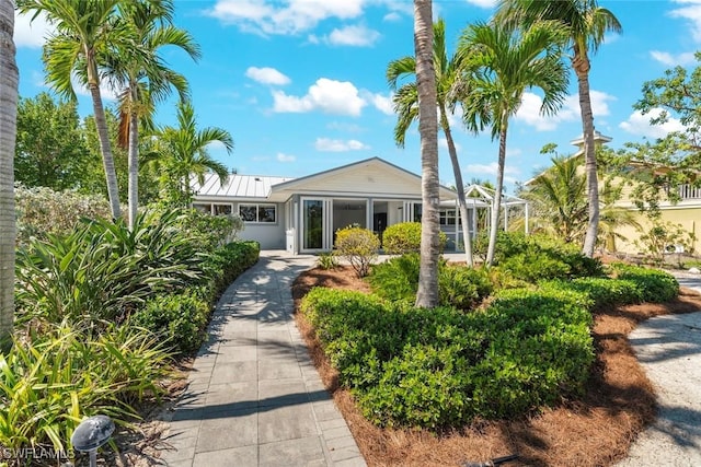 view of front of home featuring a standing seam roof and metal roof