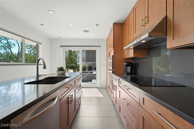 16891 Captiva Dr, Captiva, FL 33924 - kitchen with light tile patterned floors, visible vents, stainless steel appliances, a sink, and under cabinet range hood