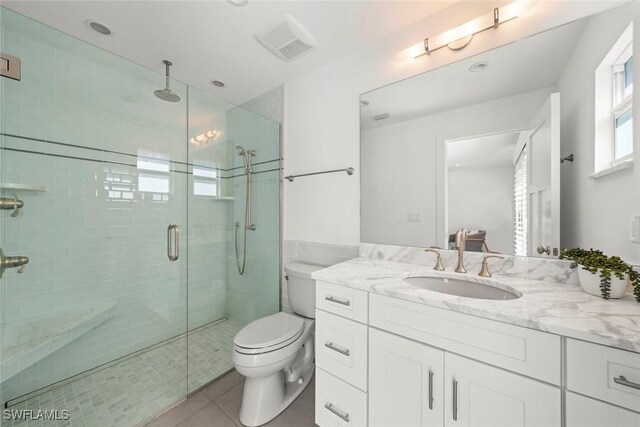 16891 Captiva Dr, Captiva, FL 33924 - bathroom featuring vanity, visible vents, a shower stall, tile patterned floors, and toilet