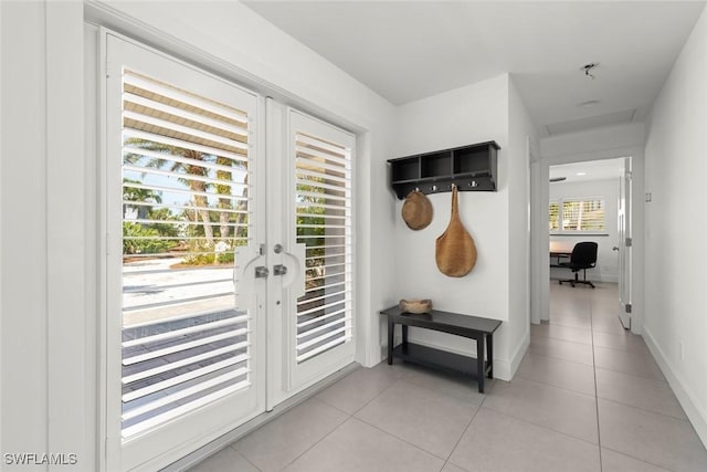16891 Captiva Dr, Captiva, FL 33924 - doorway with light tile patterned floors and baseboards