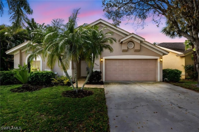 7735 Citrus Hill Ln, Naples, FL 34109 - view of front of property featuring stucco siding, driveway, and a garage