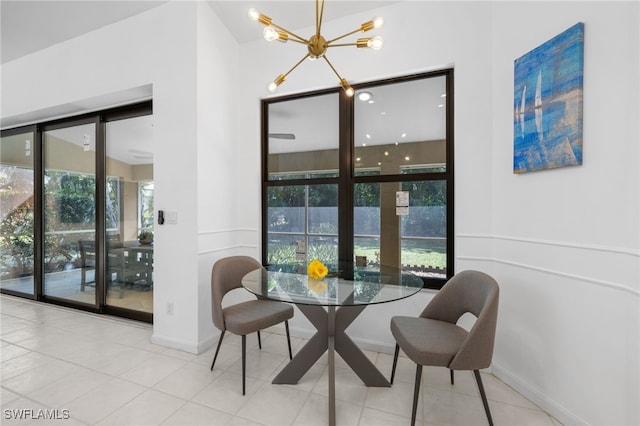 7735 Citrus Hill Ln, Naples, FL 34109 - tiled dining room featuring a chandelier and baseboards
