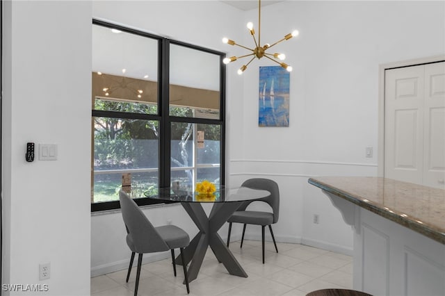 7735 Citrus Hill Ln, Naples, FL 34109 - dining area featuring a chandelier, baseboards, and light tile patterned floors