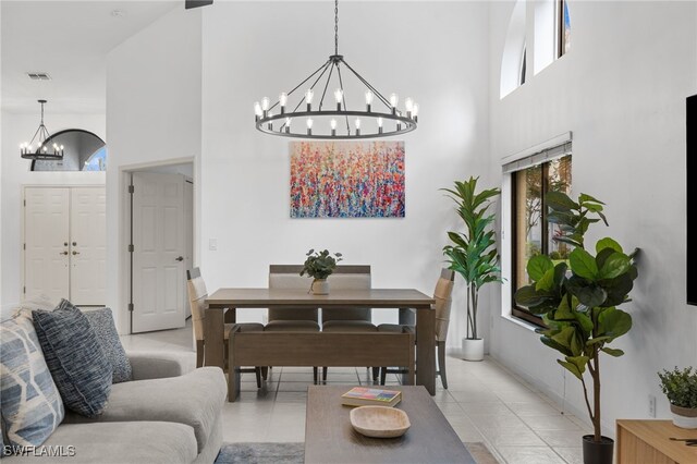7735 Citrus Hill Ln, Naples, FL 34109 - living room featuring a chandelier, a towering ceiling, healthy amount of natural light, and light tile patterned flooring
