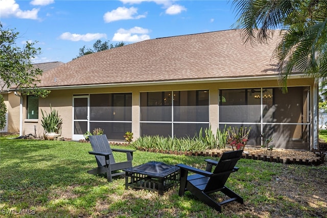 7735 Citrus Hill Ln, Naples, FL 34109 - back of house featuring a fire pit, stucco siding, a lawn, and a sunroom