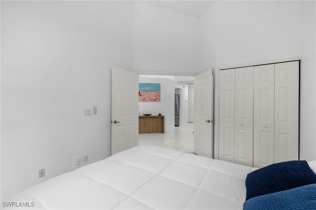 7735 Citrus Hill Ln, Naples, FL 34109 - tiled bedroom featuring a towering ceiling and a closet