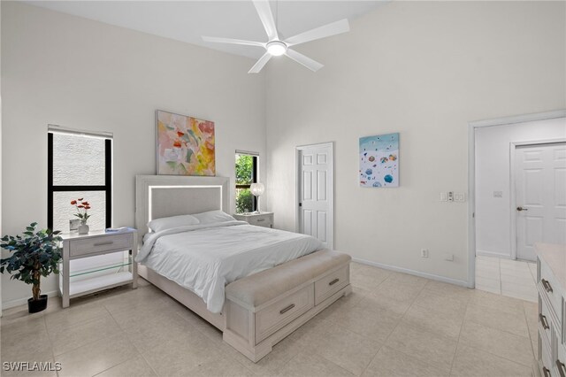 7735 Citrus Hill Ln, Naples, FL 34109 - bedroom featuring high vaulted ceiling, baseboards, light tile patterned floors, and a ceiling fan