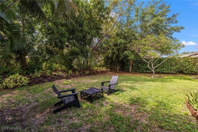 7735 Citrus Hill Ln, Naples, FL 34109 - view of green lawn featuring a fire pit