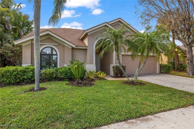 7735 Citrus Hill Ln, Naples, FL 34109 - view of front of house featuring stucco siding, concrete driveway, a front yard, an attached garage, and a shingled roof