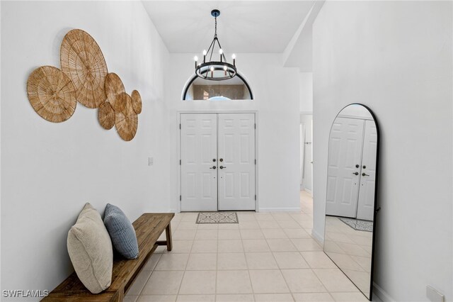 7735 Citrus Hill Ln, Naples, FL 34109 - entrance foyer with a chandelier, light tile patterned floors, and baseboards