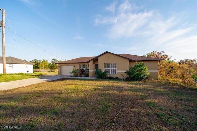 ranch-style home featuring concrete driveway, a front lawn, an attached garage, and stucco siding